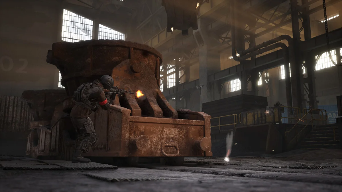 A WARDOGS soldier takes cover during a firefight inside an industrial foundry.